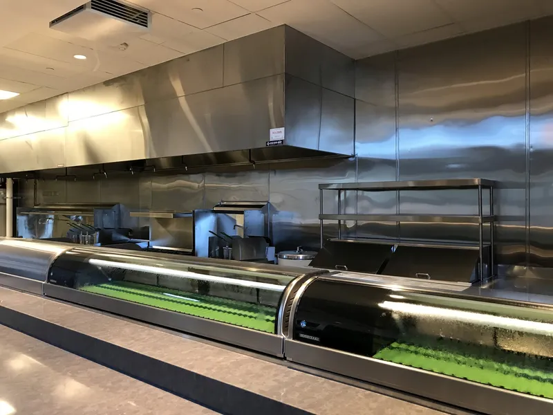 Big Catch Seafood kitchen with a full stainless steel hood and wall system above a refrigerated seafood display case